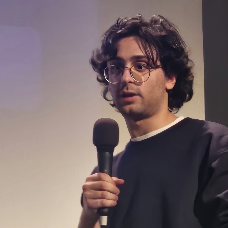 Nicholas Asseily speaking on stage